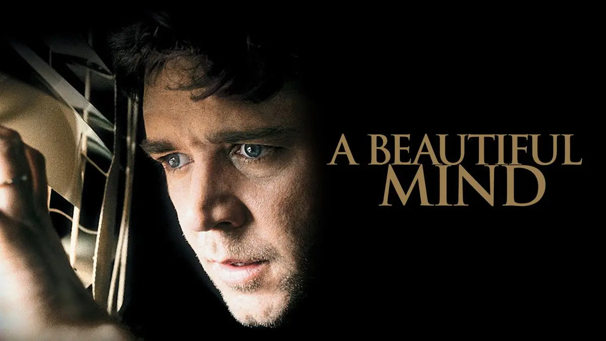 A Beautiful Mind (Akıl Oyunları) tanıtım görseli: karanlık bir camın ardından düşünceli bakan John Nash rolündeki Russell Crowe, yanında A BEAUTIFUL MIND yazısı