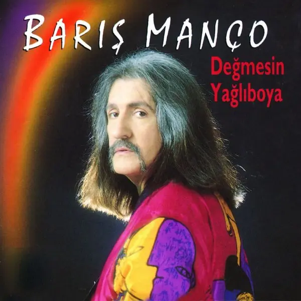 Barış Manço’nun Değmesin Yağlı Boya albüm kapağı; koyu zemin önünde rengârenk gömlekli Barış Manço