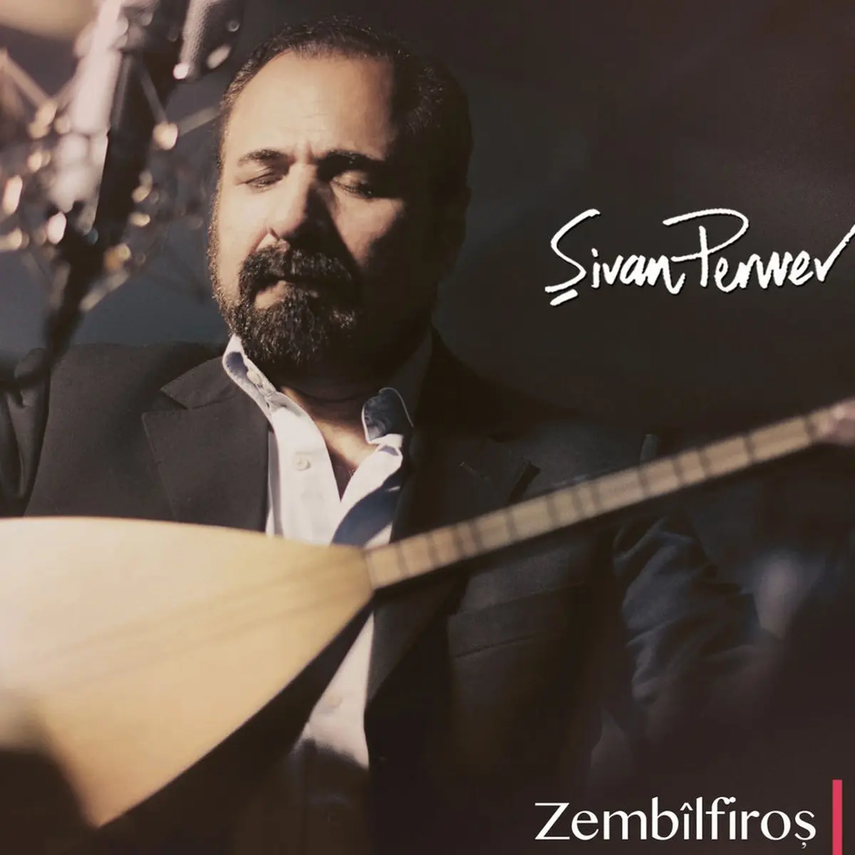 Şivan Perwer’in Zembîlfiroş albüm kapağı; koyu zemin önünde elinde tembûr tutan sakallı Şivan Perwer’in portresi