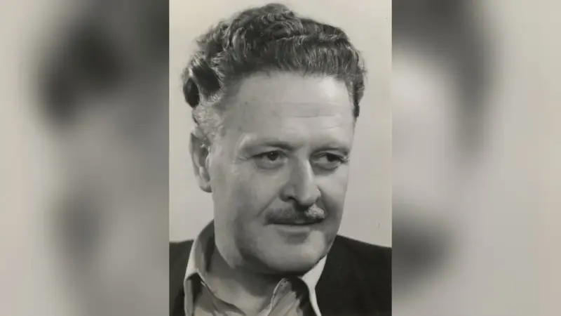 Nâzım Hikmet’in 1956’da Berlin’de çekilmiş siyah beyaz portresi; kıvırcık saçlı, bıyıklı şair hafifçe gülümseyerek yana bakıyor