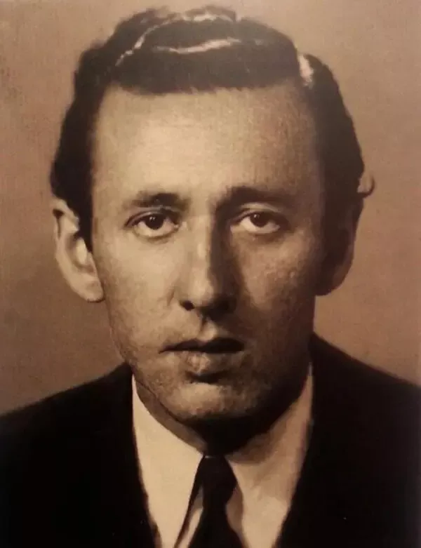 Orhan Veli Kanık'ın geriye taranmış koyu saçları, beyaz gömleği ve kravatıyla kameraya baktığı sepya tonlu portre fotoğrafı