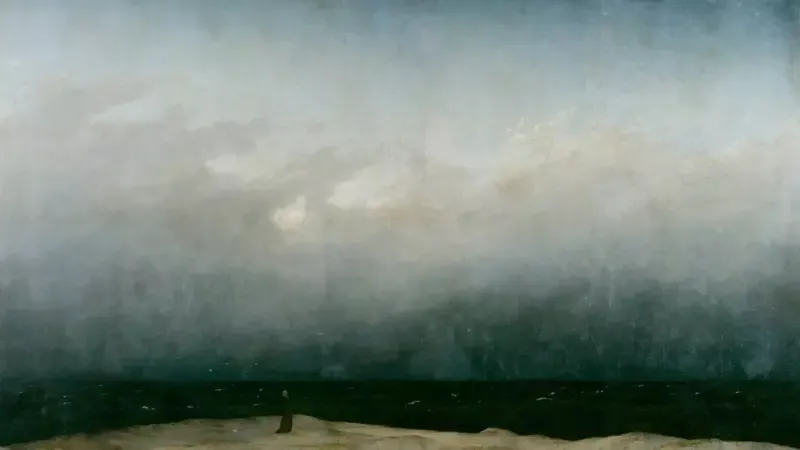 Caspar David Friedrich’in Deniz Kıyısındaki Keşiş tablosu; bulutlu, geniş bir gökyüzünün altında koyu denizin kıyısındaki kumsalda tek başına duran küçük bir keşiş figürü